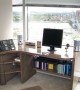 Customized Parsons desk with matching shelving beautifully maximizes the working area in a difficult space  