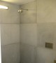 42x42 inch concrete panels tile the entire bathroom including the shower area, Kim Residence, New York, NY