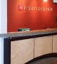 Reception desk incorporating concrete tops and elements with wood and laminates
